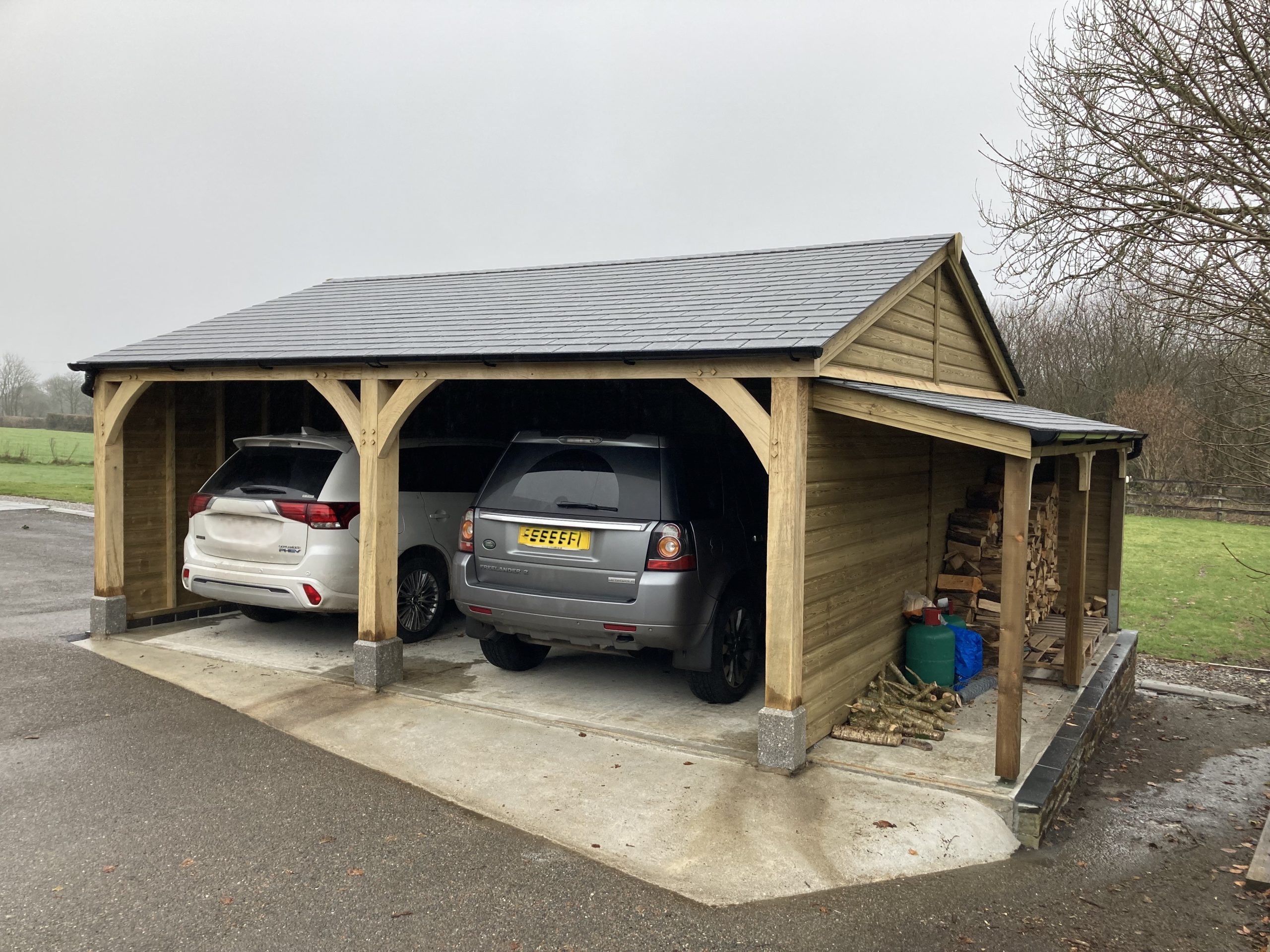 Double oak fronted carport and log store